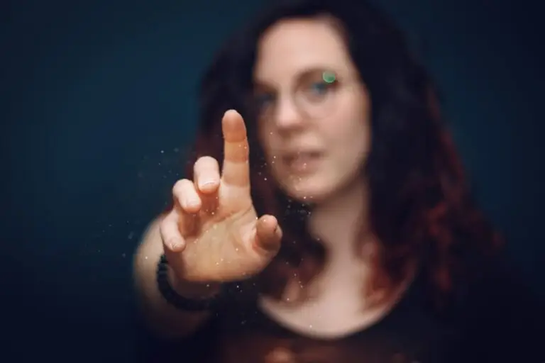 A woman reaching out with her finger, creating a sense of interaction and curiosity.